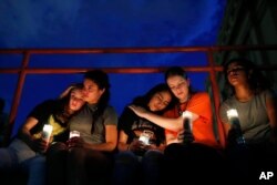 From left, Melody Stout, Hannah Payan, Aaliyah Alba, Sherie Gramlich and Laura Barrios comfort each other during a vigil for victims of the shooting, Aug. 3, 2019, in El Paso, Texas.