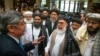 FILE - Russian presidential envoy to Afghanistan Zamir Kabulov, left, speaks with Taliban representatives prior to their talks in Moscow, May 28, 2019.