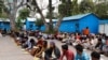 Daily wage workers and homeless people eat food inside a government-run night shelter during a 21-day nationwide lockdown to limit the spreading of coronavirus disease (COVID-19), in the old quarters of Delhi, India, March 26, 2020. 