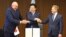 Britain's Defense Minister Grant Shapps, right, Italy's Defense Minister Guido Crosetto, left, and Japanese Defense Minister Minoru Kihara, center, shake hands after a signing ceremony for Global Combat Air Programme at the defense ministry Dec. 14, 2023, in Tokyo, Japan. 