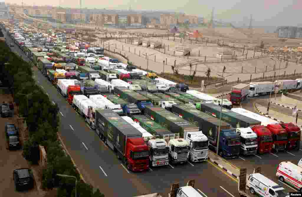 Trucks carrying humanitarian aid wait to start moving to the Rafah border crossing to enter Gaza, amid a ceasefire between Israel and Hamas, in Cairo, Egypt.