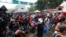 Migrants attempt to cross the border from Corinto, Honduras, into Corinto, Guatemala, Oct. 1, 2020. 