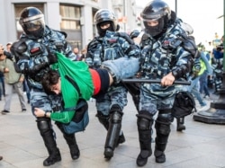 Police detain a man during a protest in Moscow, Russia, Aug. 10, 2019.