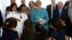 German Chancellor Angela Merkel (C) distributes shirts of the German national soccer team to Lebanese and Syrian displaced students studying together, during her visit to a Lebanese public school, in Beirut, Lebanon, June 22, 2018.