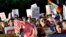 FILE - Protesters march through downtown Phoenix, May 1, 2017. Immigrant and union groups marched in cities across the United States on Monday to mark May Day and protest against President Donald Trump's efforts to boost deportations. 