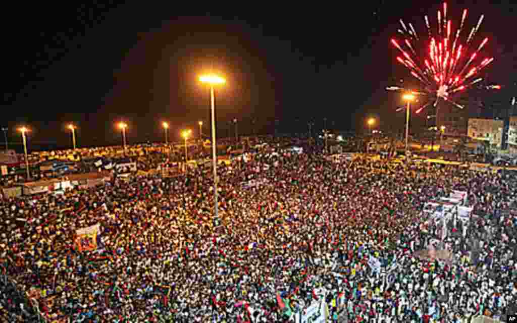 Fireworks explode as people gather near the courthouse in Benghazi to celebrate the entry of rebel fighters into Tripoli. Jubilant rebel fighters streamed into the heart of Tripoli as Muammar Gaddafi's forces collapsed and crowds took to the streets to ce