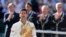Novak Djokovic of Serbia reacts while holding the winner's trophy after defeating Roger Federer of Switzerland in their men's singles finals tennis match on Centre Court at the Wimbledon Tennis Championships in London July 6, 2014. 