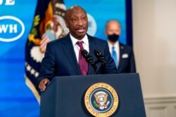 FILE - Merck Chairman and CEO Kenneth Frazier, left, accompanied by President Joe Biden, speaks in the South Court Auditorium in the Eisenhower Executive Office Building on the White House Campus, March 10, 2021.