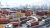 Trucks line up to enter Port Miami after the union representing 45,000 striking U.S. dockworkers reached a deal to suspend a three-day strike, Oct. 4, 2024, in Miami. 