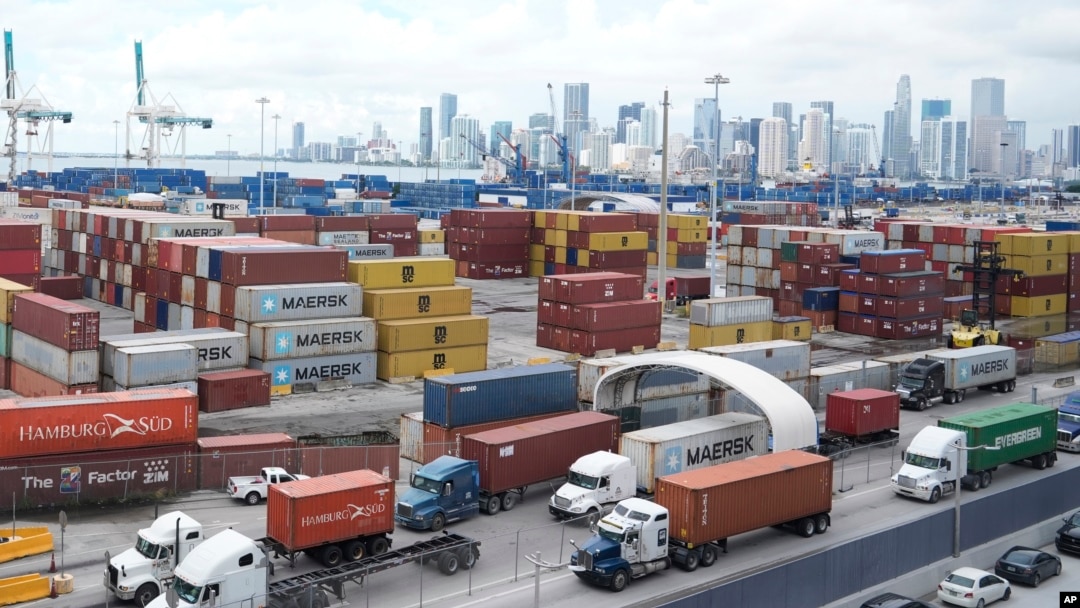 Trucks line up to enter Port Miami after the union representing 45,000 striking U.S. dockworkers reached a deal to suspend a three-day strike, Oct. 4, 2024, in Miami. 