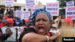 A protester shouts as she attends a mass protest demanding the resignation of Mali's President Ibrahim Boubacar Keita in Bamako, Mali, Aug. 11, 2020. 