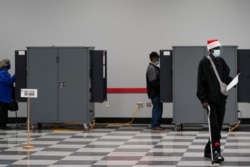 People cast their ballots in the U.S. Senate runoff elections on the first day of early voting in Atlanta, Georgia, Dec. 14, 2020.
