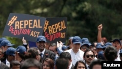 Malaysian lawyers hold placards and shout slogans during a protest calling for the repeal of the Sedition Act in Kuala Lumpur, October 16, 2014.