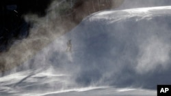 A course worker is shrouded in snow as it blows across the course where the technical events will be held before an inspection by competitors in the women's giant slalom at the Yongpyong Alpine Center at the 2018 Winter Olympics in Pyeongchang, South Kore