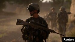 US Army soldiers patrol in the Afghan village of Chariagen in the Panjwai district of Kandahar province on June 22 , 2011. 