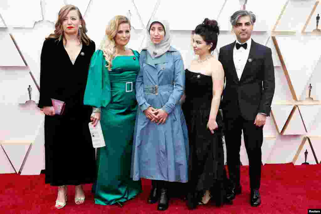 Director Feras Fayyad poses with Sigrid Dyekjaer, Kirstine Barfod, Amani Ballour and Alisar Hasan on the red carpet during the Oscars arrivals at the 92nd Academy Awards in Hollywood.