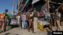 Indian police frisk a Kashmiri man during a cordon and search operation ahead of a concert by the Bavarian State Orchestra and renowned conductor Zubin Mehta in Srinagar, Sept. 5, 2013.