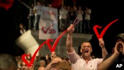 Supporters of the opposition party "Vetevendosje" hold heart signs during the closing election campaign rally in Kosovo capital Pristina, June 9, 2017. Kosovars go to the polls Sunday to choose the new 120-seat parliament.