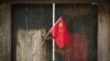 FILE - A Chinese national flag is displayed on a door in a traditional alleyway in Beijing, China, July 7, 2024. An advocacy group estimates that 11 U.S. nationals are currently wrongfully detained in China.