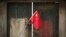 FILE - A Chinese national flag is displayed on a door in a traditional alleyway in Beijing, China, July 7, 2024. An advocacy group estimates that 11 U.S. nationals are currently wrongfully detained in China.