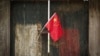 FILE - A Chinese national flag is displayed in a traditional alleyway in Beijing, China, July 7, 2024. 