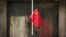 FILE - A Chinese national flag is displayed in a traditional alleyway in Beijing, China, July 7, 2024. 