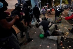 Oregon State Police arrest a protester in Portland, Ore., Nov. 4, 2020, following Tuesday's election.