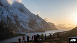 FILE - Tourists from China photograph a fjord in Unstad on Lofoten Islands, on March 2, 2023.