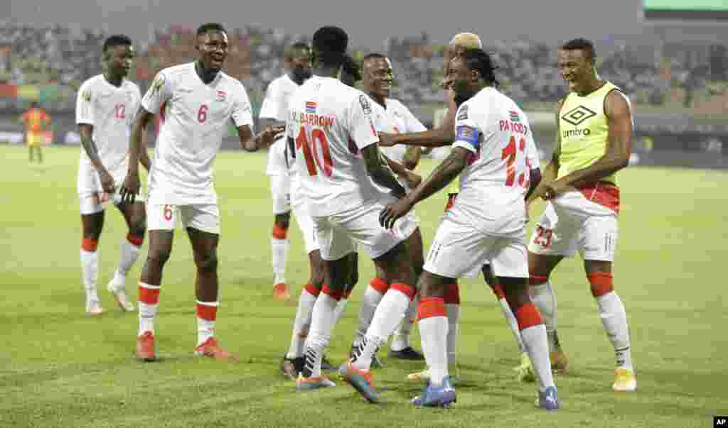 Gambia's Musa Barrow celebrates with teammates after scoring during the round of 16 match between Guinea and Gambia in Cameroon, Jan. 24, 2022.