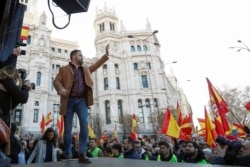 Santiago Abascal, leader of the far-right party VOX, waves to supporters during a rally in protest against the new coalition government led by Spain's Prime Minister Pedro Sanchez, at Cibeles Square in Madrid, Spain, Jan. 12, 2020.