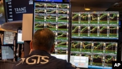 People work on the New York Stock Exchange trading floor in New York, Nov. 21, 2024. U.S. stocks rose on Nov. 25, 2024, with those benefiting the most from lower interest rates and a stronger economy leading the way. 