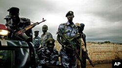 Members and supporters of the Southern Sudan police as they escort a Referendum march through the southern capital of Juba, in this file photo dated Monday, August 2010. Southern Sudan is eagerly awaiting a January vote that could break Africa's largest country into two. North-South negotiations have barely begun, though, and tensions are already rising, as the south accuses the north of playing a stall game designed to delay the vote. (AP Photo/Pete Muller)