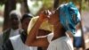 Woman drinking the first dose of the first oral vaccine against cholera in Africa during an epidemic, Guinea, Tougnifili/Mankountan, 2012. Photo by David Di Lorenzo/MSF. 