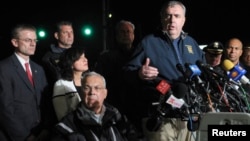 Boston Police Commissioner Ed Davis (CR) stands next Boston Mayor Tom Menino (bottom) as he answers questions about the capture of Dzhokhar Tsarnaev, the second suspect in the Boston Marathon bombing, in Watertown, Massachusetts, April 19, 2013.