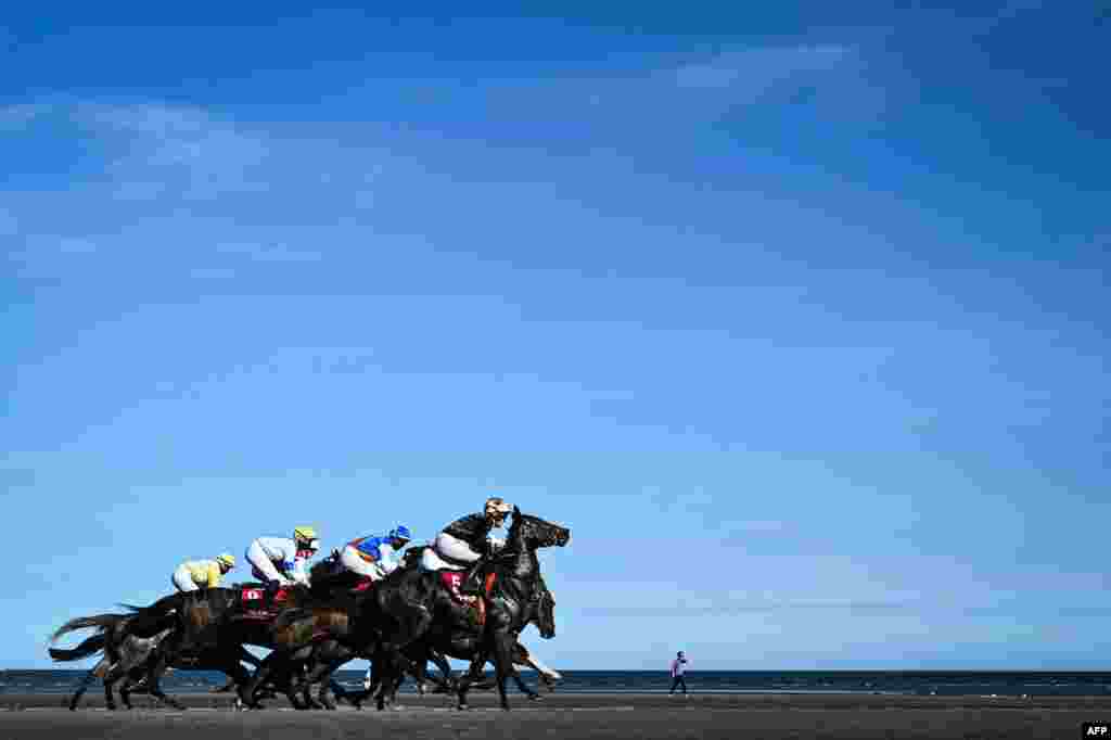 Horses compete on the first race over the sand, on the course on Laytown beach, in County Meath on the east coast of Ireland, during The Laytown Races.