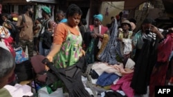 FILE - People go through secondhand clothes at the Kantamanto market in Accra, Ghana, on November 15, 2023.