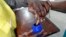 FILE - A voter's finger is marked after voting in the general election in Maputo, October 2014.