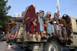 Taliban fighters in a vehicle patrol the streets of Kabul, on August 23, 2021.