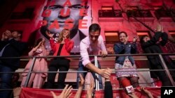 FILE - Spain's Prime Minister and Socialist Party leader Pedro Sanchez shakes hands with supporters outside the party headquarters following the general election in Madrid, Spain, April 28, 2019.