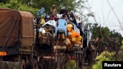 Muslims fleeing sectarian violence are on top of a truck with their belongings -- on the road between Bangui and Sibut -- on a convoy being escorted by French peacekeepers to the south eastern town of Bambari, Central African Republic, April 20, 2014.