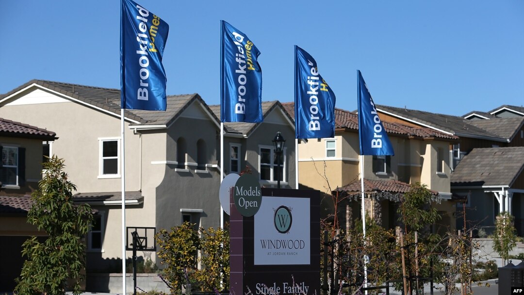 FILE - A sign advertising new homes is posted at a housing development in Dublin, California.