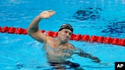 Caeleb Dressel, of the United States, celebrates after winning the gold medal in the men's 50-meter freestyle final at the 2020 Summer Olympics, Aug. 1, 2021, in Tokyo, Japan. 