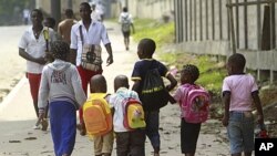 Students walk along a street after classes in Bata. The African Nations Cup is being co-hosted by Equatorial Guinea and Gabon from January 21 to February 12, January 19, 2012.