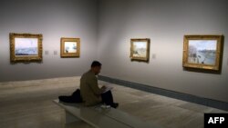 FILE - A man attends the opening of the first monographic exhibition in Spain on Danish-French impressionist painter Camille Pissarro at the Thyssen-Bornemisza museum in Madrid, June 3, 2013. 