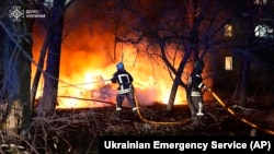 In this photo provided by the Ukrainian Emergency Service, firefighters extinguish the fire following a Russian rocket attack that hit a multi-story apartment building in Sumy, Ukraine, Nov. 17, 2024.