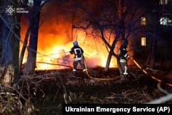 In this photo provided by the Ukrainian Emergency Service, firefighters extinguish the fire following a Russian rocket attack that hit a multi-story apartment building in Sumy, Ukraine, Nov. 17, 2024.