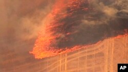 This aerial image made from video provided by FOX 12 News shows a grassland fire burning near The Dalles, Ore., July 18, 2018. The fast-moving deadly fire fueled by gusting winds in the Pacific Northwest forced dozens of households to evacuate and prompted Oregon Gov. Kate Brown to declare a state of emergency Wednesday.