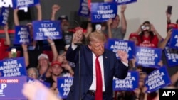 Former US President and Republican presidential candidate Donald Trump dances as he concludes his remarks during a campaign event at the Bayfront Convention Center in Erie, Pennsylvania, September 29, 2024. (Photo by DUSTIN FRANZ / AFP)