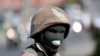 FILE - A member of the South African National Defense Force looks on during a patrol in an attempt to enforce a nationwide lockdown, aimed at limiting the spread of the coronavirus disease, in Alexandra township, South Africa, March 28, 2020.
