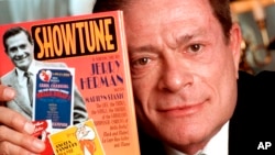 FILE - In this Nov. 19, 1996, file photo, composer Jerry Herman displays his book "Showtune," in New York.